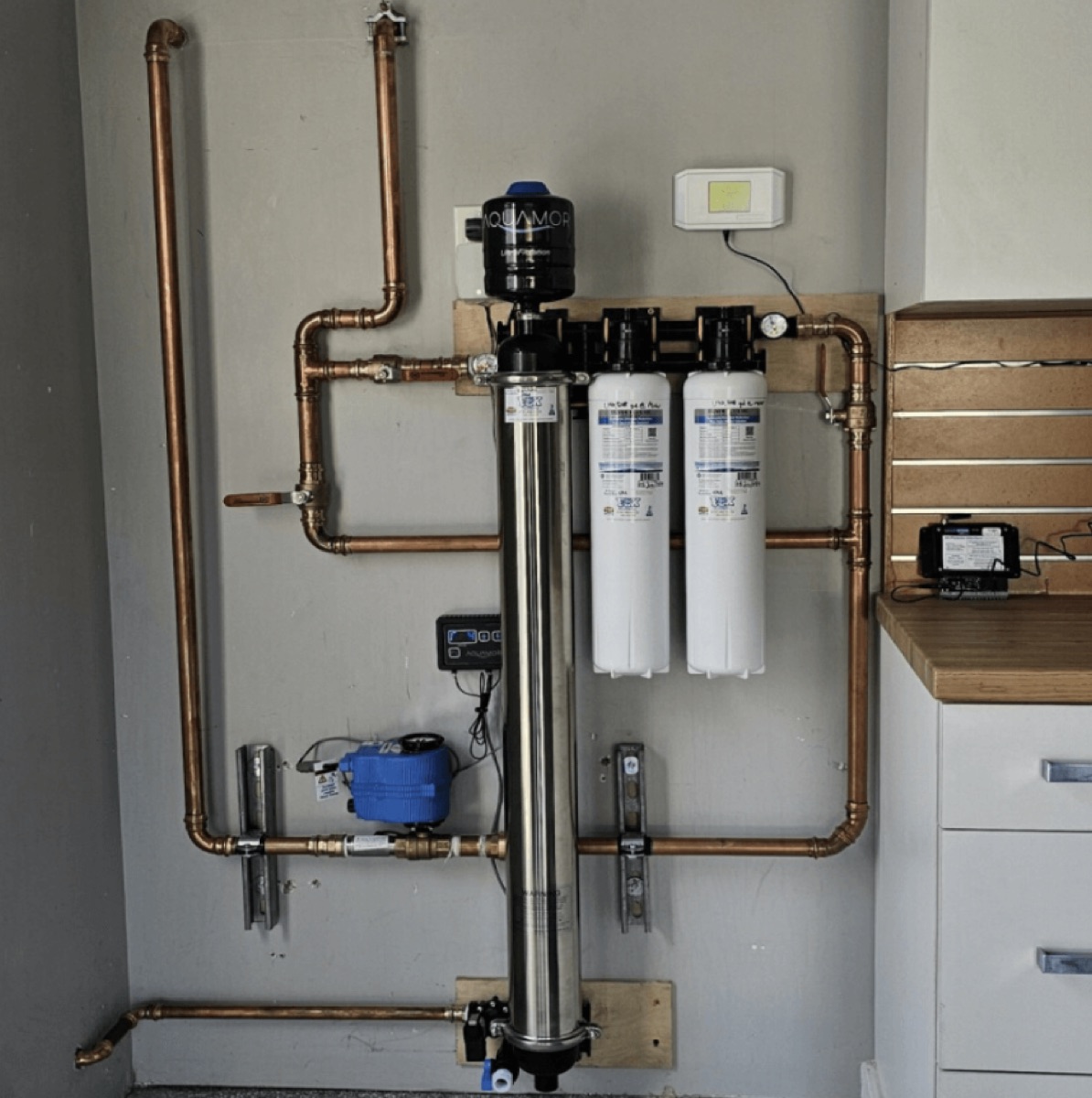 Apache Diamond Ultra whole-home system installed in a garage with copper plumbing