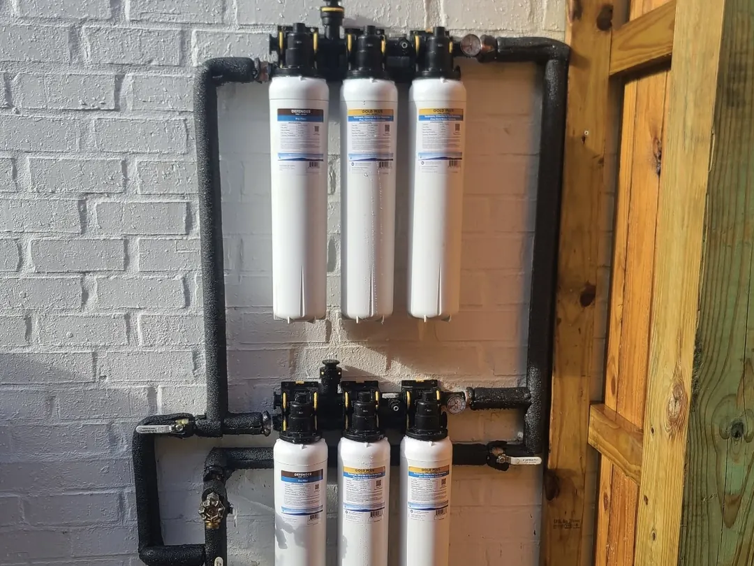 Dual Apache Gold whole-home systems stacked in two banks on an exterior brick wall
