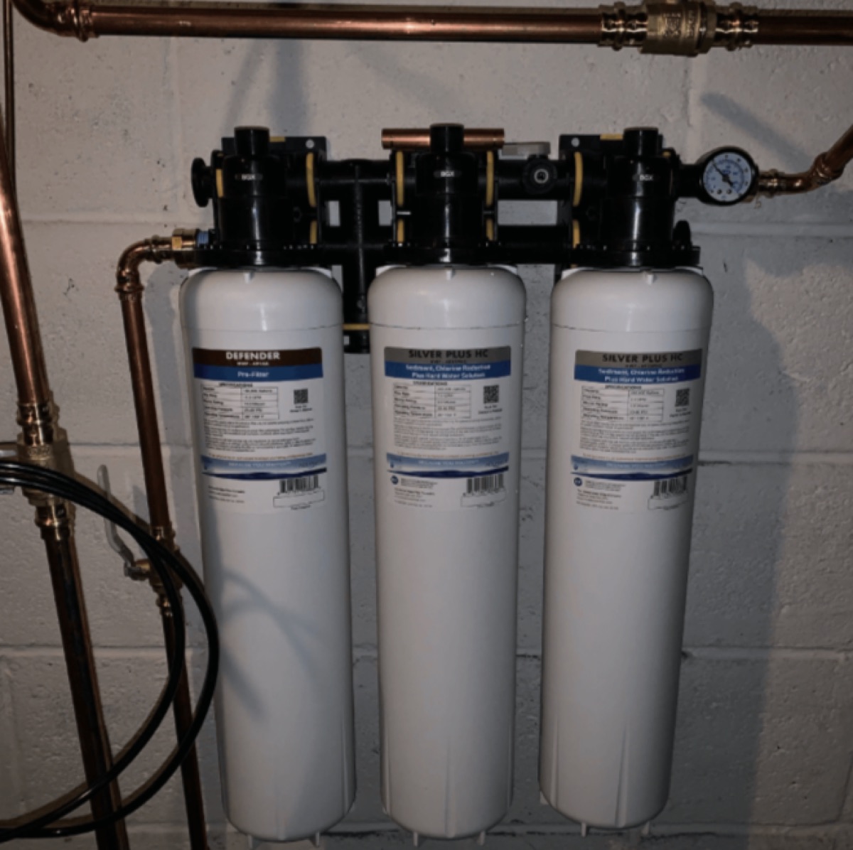 Apache Silver whole-home system installed in a utility room with copper plumbing